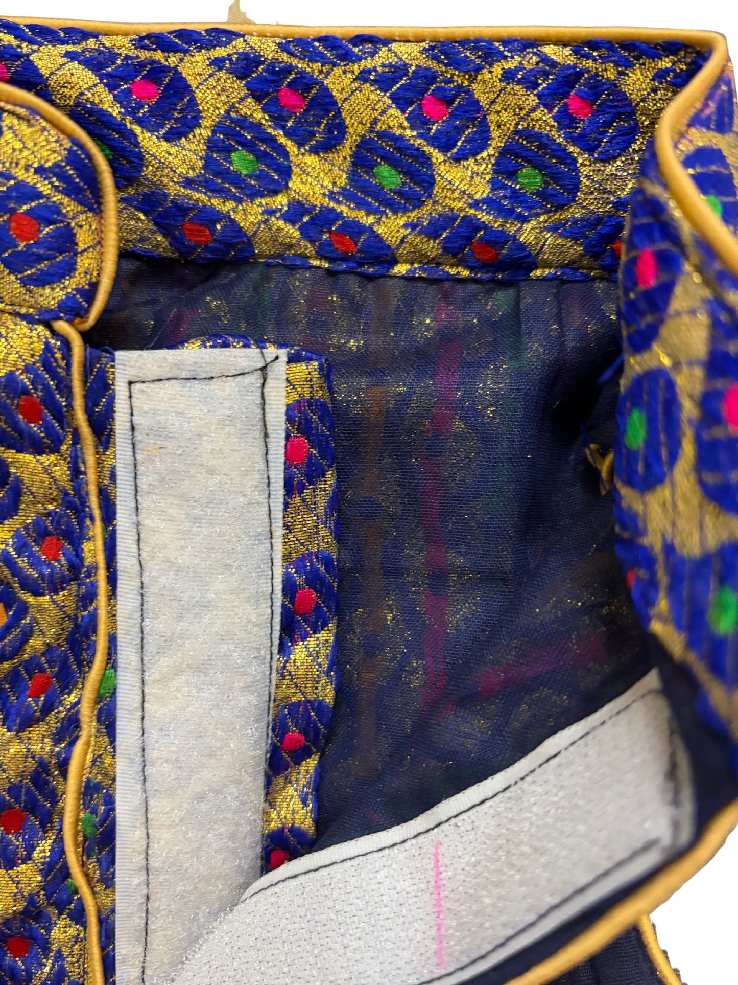 Close-up of a fabric with intricate blue and gold pattern