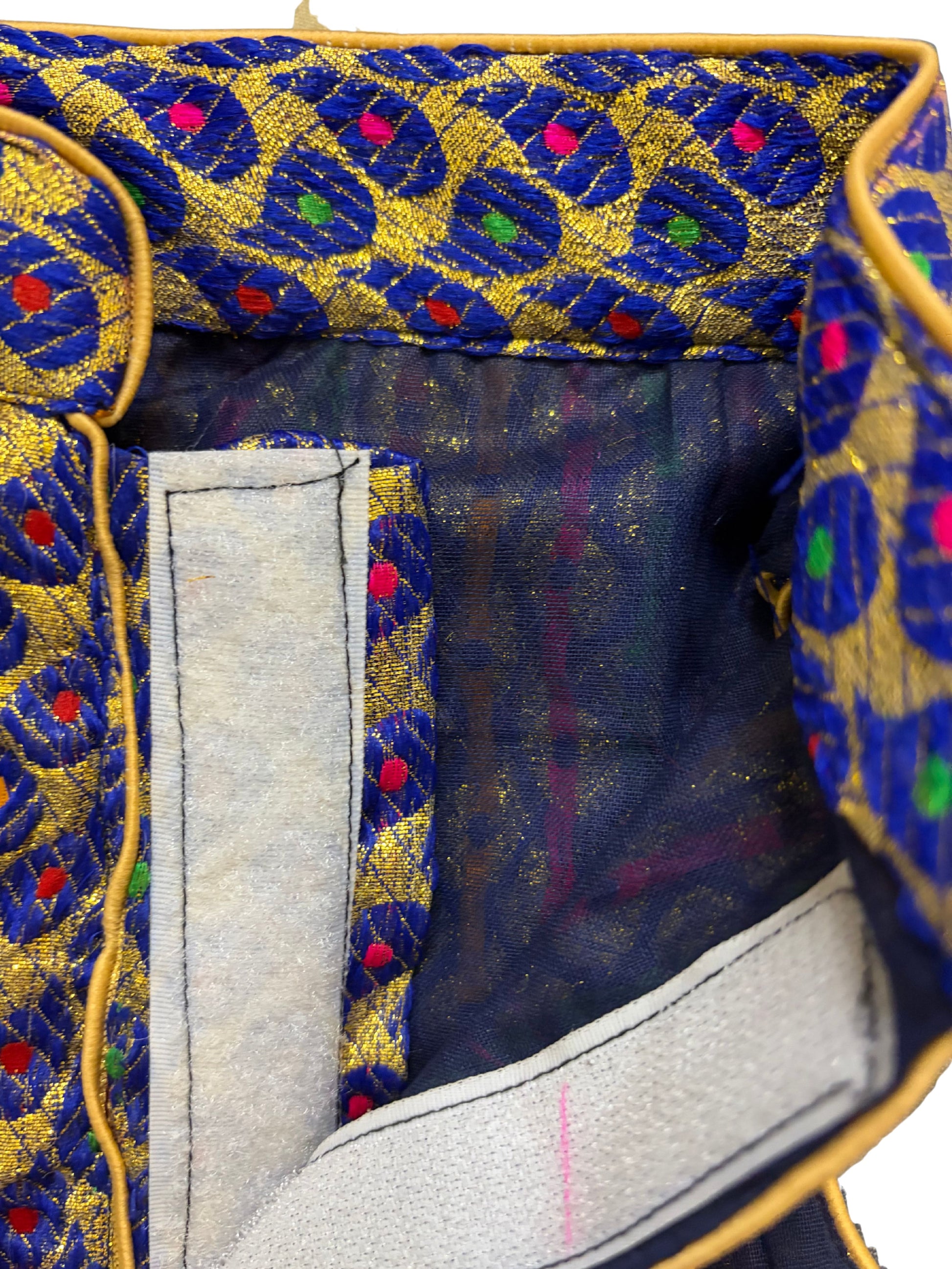 Close-up of a fabric with intricate blue and gold pattern