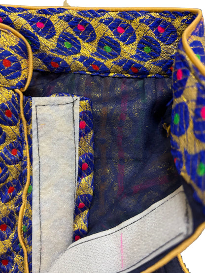 Close-up of a fabric with intricate blue and gold pattern