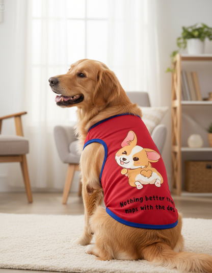 Dog wearing a red shirt with a cartoon dog design in a living room.