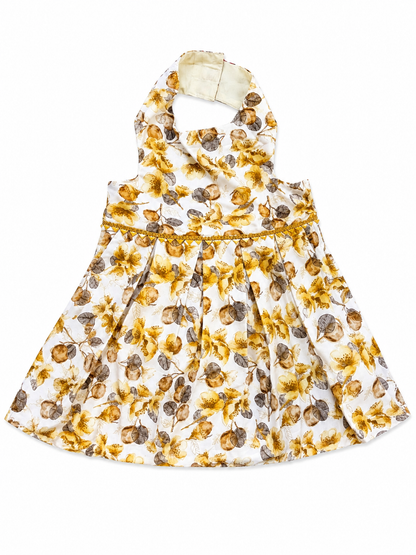 Floral dress with yellow and brown pattern on a white background