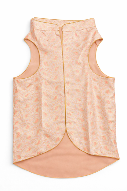 Light pink sleeveless top with subtle pattern on a white background