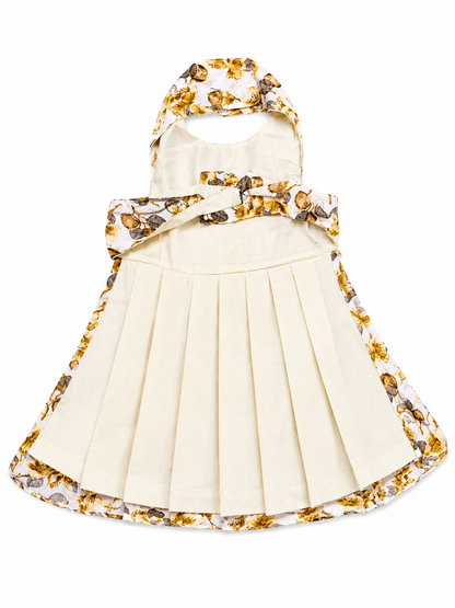 White dress with gold floral accents on a white background