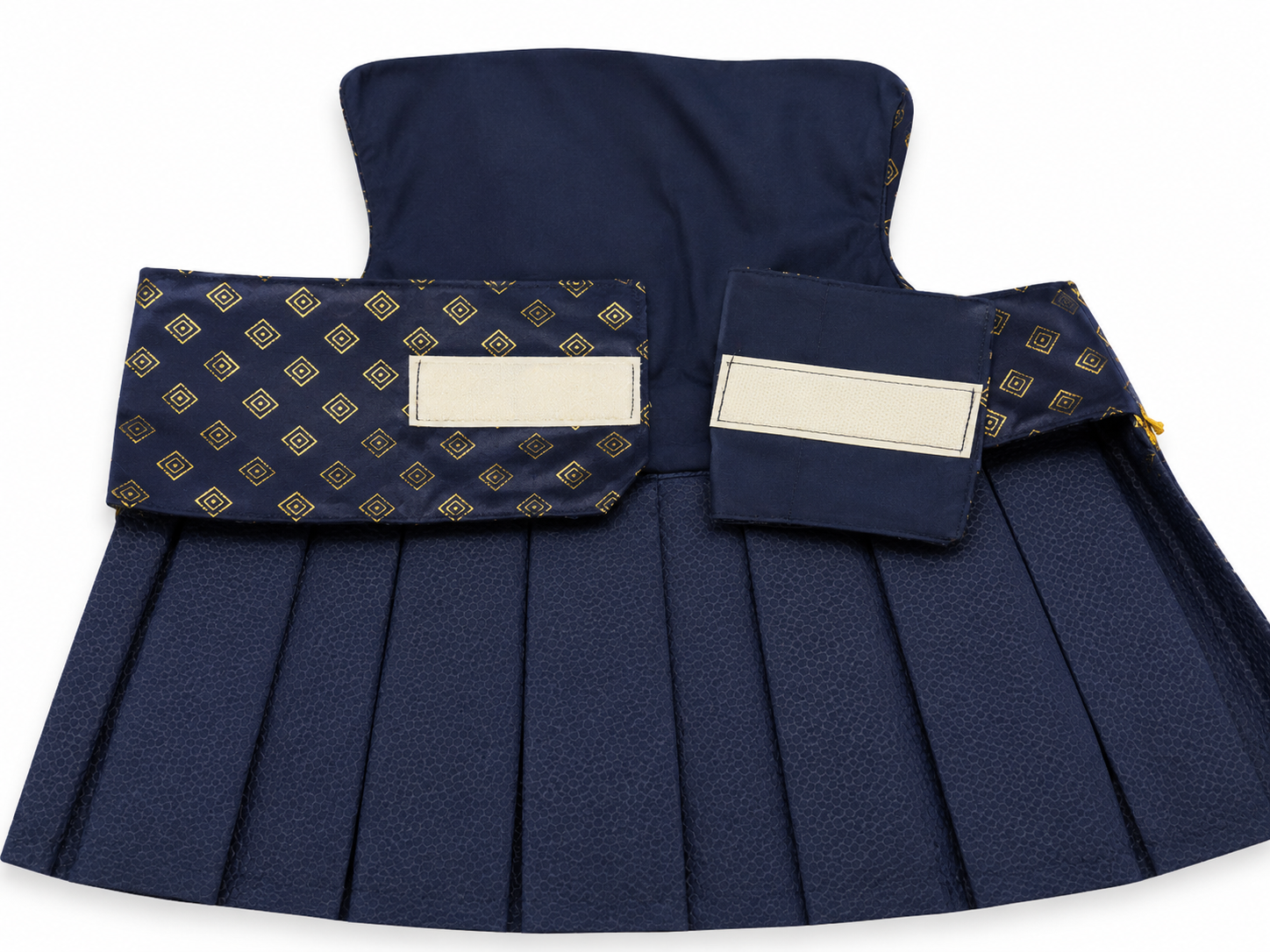 Navy pleated skirt with patterned pockets on a white background